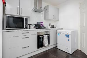 A kitchen or kitchenette at Remaj Serviced Accommodation, sleeps 7 & free parking