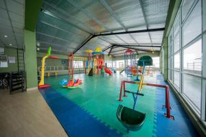 a gym with a pool with slides and play equipment at Olympus Plaza Hotel in Haputale