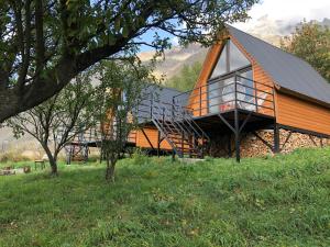 a house with a large deck on a hill at Kazbegi Kuro Cottages in Kazbegi