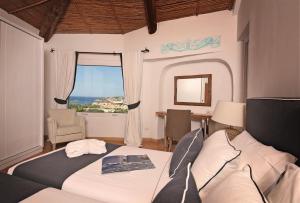 a bedroom with a bed and a large window at Residence Balocco Porto Cervo in Porto Cervo