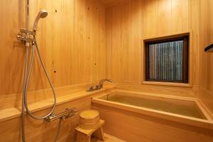a wooden bathroom with a tub and a shower at 祇園の宿 杏花 in Kyoto +37 photos