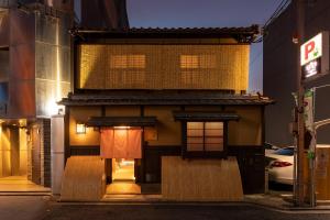 a building on a street at night at 祇園の宿 杏花 in Kyoto