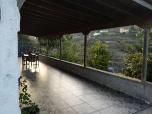 a balcony of a house with a table and chairs at Casa Rural Ramón in Agulo