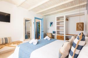 a bedroom with a large bed and a tv at Suites Las Vistas by Menorca Vacations in Son Bou