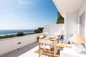a living room with a view of the ocean at Suites Las Vistas by Menorca Vacations in Son Bou
