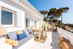 a balcony with a table and chairs and a view of the ocean at Suites Las Vistas by Menorca Vacations in Son Bou