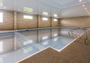 a large swimming pool in a large room with at Kinloch Hotel, Isle of Arran in Blackwaterfoot