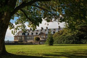 a large building on top of a lush green field at The Gleneagles Hotel in Auchterarder