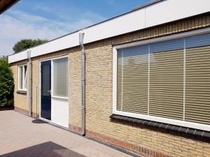 a building with blinds on the side of it at Mooi zo 1 in De Koog +15 photos