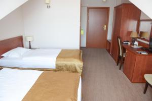 Łóżko lub łóżka w pokoju w obiekcie Hotel Vis a Vis Łańcut