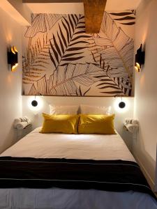 a bedroom with a large bed with yellow pillows at Luxe et Calme en Hyper Centre - La Cour des Bois in Lyon