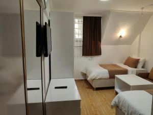 a small hotel room with two beds and a tv at Hotel Best Apart in Istanbul