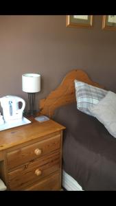 a bedroom with a bed and a night stand with a lamp at The Fleece Inn in Bishop Wilton
