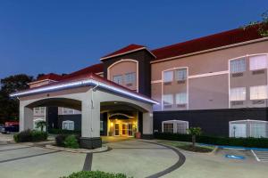 a hotel with a parking lot in front of it at La Quinta by Wyndham I-20 Longview South in Longview
