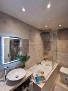 a bathroom with a tub and a sink and a toilet at Sunrise View 2 Bed Apartment Sleeps 4 Spa Bath in Bridlington