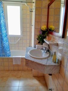a bathroom with a sink and a mirror and a tub at Villa Margarita in Cala Millor