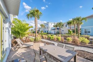 a patio with a table and chairs and palm trees at Gorgeous Margaritaville Cottage wPrivate Patio in Orlando