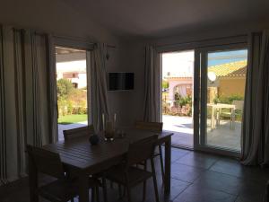 a dining room with a table and a sliding glass door at Perla in Budoni