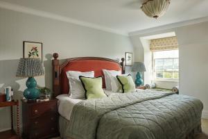 a bedroom with a bed and two lamps and a window at The Gleneagles Hotel in Auchterarder