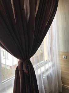 a curtain in front of a large window at Hostel Iskra in Lviv