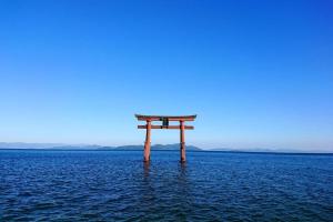 a torii gate in the middle of the water at Farm stay inn Sanzaemon-tei 母屋GuestHouse Shiga-Takasima Traditional Japanese architecture house in Takashima