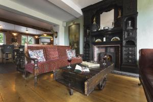 a living room filled with furniture and a fireplace at Lyth Valley Country House in Kendal