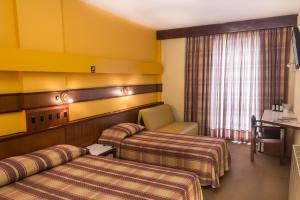 Tempat tidur dalam kamar di Hotel Vinocap