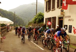 a group of people riding bikes down a street at Osteria Grütli con alloggio in Borgnone