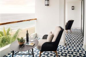 a patio with a table and chairs and the beach at Hotel Fariones in Puerto del Carmen
