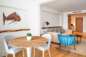 a living room with a table and a couch at Hotel Fariones in Puerto del Carmen