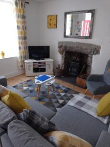 a living room with a couch and a fireplace at The Sidings Wales in Blaenau-Ffestiniog