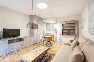 a living room with a couch and a table at Apartamento lujo castellana chamartín in Madrid