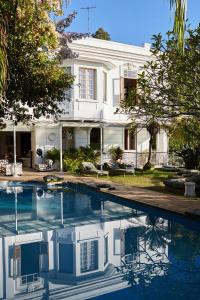 a house with a swimming pool in front of a house at Mama Ruisa Boutique Hotel in Rio de Janeiro