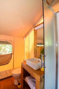 a bathroom with a sink and a toilet at EKOLODJ MANTEN in Lamentin