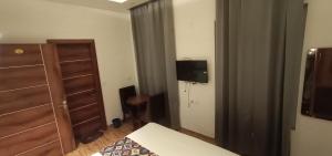 a bedroom with a bed and a dresser and a television at Hotel Ontario in Patiāla