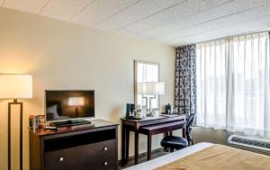 a hotel room with a desk and a television at Mountaineer Casino Resort in New Cumberland