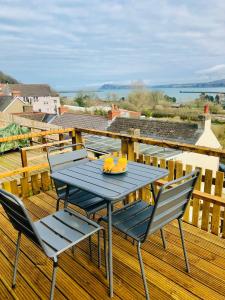 a blue table and chairs on a deck at Artro House in Pembrokeshire