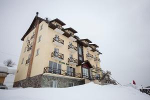 a building on top of a snow covered slope at Hotel Donata in Gudauri