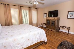 a bedroom with a bed and a flat screen tv at Lakeside 312 at Bluewater Bay Resort in Niceville +21 photos