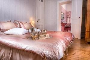 a bedroom with a bed with a tray of teaiments on it at Le Château des Tourelles en Vendée in La Gaubretière +65 photos