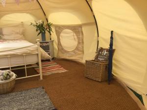 a bedroom with a bed in a tent at Horsemans Stargazing Tent in Kingsbridge