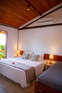 Säng eller sängar i ett rum på Tororao Hotel Pousada