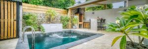 a swimming pool in the middle of a yard at VILLA TAMARIN in Ravine des Cabris