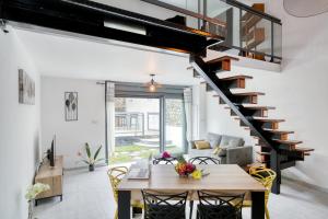 a living room with a table and a staircase at VILLA TAMARIN in Ravine des Cabris