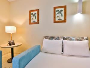 a bedroom with a bed and a table with a telephone at Thermas de Olimpia Resort in Olímpia +82 photos