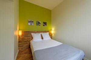 Postel nebo postele na pokoji v ubytování Appart Hôtel Lyon Villemanzy