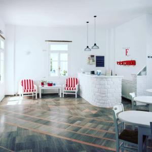 a living room with red and white chairs and a table at Fisilanis Beachfront Hotel in Logaras