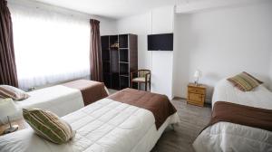 Säng eller sängar i ett rum på Hostal Ventisqueros