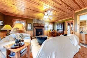 a living room with white furniture and a wooden ceiling at Tranquility Place in Lakemont