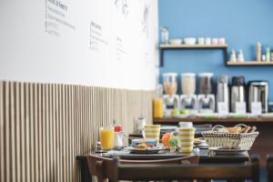 a table with plates of food and glasses of orange juice at Hostal Ventisqueros in Punta Arenas